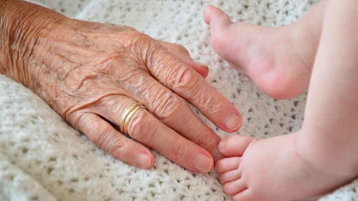 Grootouder overhandigt een envelop met geld aan een jong kleinkind als schenking